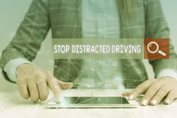 Handwriting text writing Stop Distracted Driving. Conceptual photo asking to be careful behind wheel drive slowly Female human wear formal work suit presenting presentation use smart device