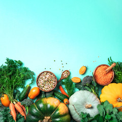 Organic vegetables, lentils, beans, raw ingredients for cooking on trendy green background. Healthy, clean eating concept. Vegan or gluten free diet. Copy space. Top view. Food frame