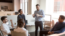 Serious Team Leader Talk To Diverse Business People At Meeting