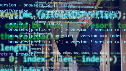 Wall Mural - programming code is emerging above the image of the computer engineer