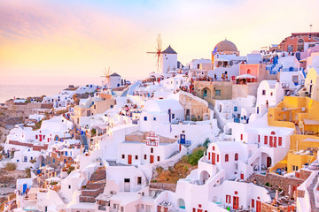 Wall Mural - Beautiful view of picturesque village of Oia with traditional white architecture  and windmills in Santorini island in Aegean sea at sunset, Greece. Scenic travel background.