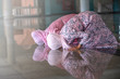 © rachaphak - Hands of two muslim woman on the reflection floor praying in traditional clothes.