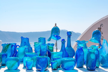 Wall Mural - Traditional souvenirs in Oia town on Santorini island, Greece. Blue glass vases, lamps - objects to decorate the interior of the home in mediterranean style