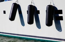 View On White Boat Side Of Luxury Yacht With Three Black Fenders In Natural Bright Sun Light - Marine De Cogolin, France