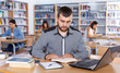 © JackF - man engaged in research, working with laptop and books