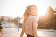 © Dima Aslanian - Happy woman woman with beautiful hair walking in the city under sunlight. Turn around