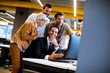 © BGStock72 - Senior businesswoman and young business people work in a  office