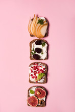 Trendy Sandwiches With Fresh Fruits, Like Pomegranate, Figs, Mulberry And Pears. Healthy Food Concept  With Different Sandwiches With Vibrant Color  Style.