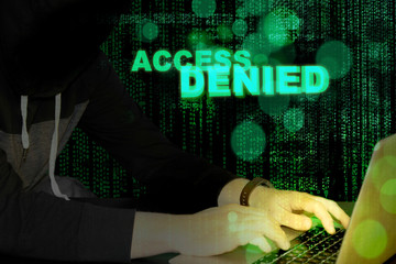 Access denied - hacker and laptop with code background