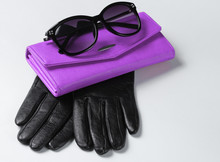 Purple Leather Wallet, Sunglasses, Gloves Close-up On White Background