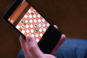 Game chess app for smartphone. The concept of business communication technology. Business strategy. Digital gadget. Computer use.