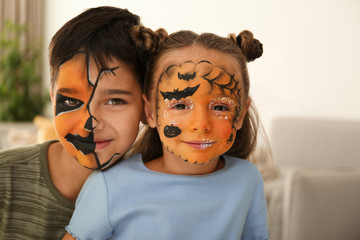 Cute little children with face painting indoors