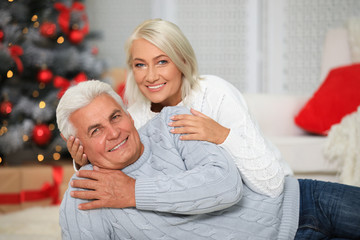 Wall Mural - Happy mature couple at home. Christmas celebration