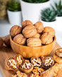 © ozgur - Whole walnuts in bowl. Dried figs with walnuts on wooden background.