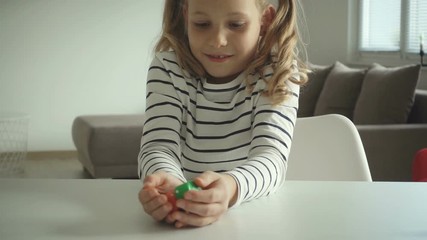 Wall Mural - Cute little girl playing dices at home