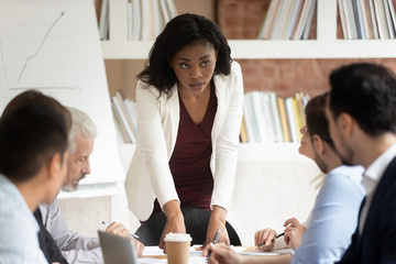 Poster - Serious millennial black businesswoman head company briefing in office