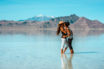 Wall Mural - Couple kissing near water in the summer