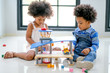 © narong - Two African brother and sister play some toys together in the room with day light with main focus on little girl.
