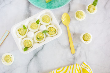 Wall Mural - Avocado Deviled Eggs on Blue Plate