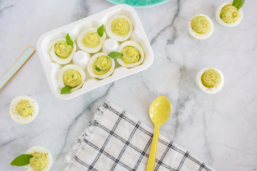 Wall Mural - Avocado Deviled Eggs on Blue Plate