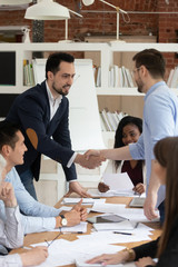 Wall Mural - Male employees handshake get acquainted at business meeting