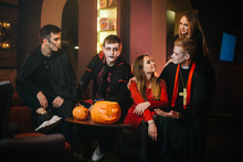 Guy In Count Dracula's Halloween Costume Is Sitting With Friends In A Cafe And Looking At The Camera