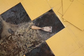 Old vinyl tiles removal from floor in a room or kitchen