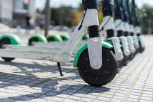 Lime Electric Push Kick Scooter Sharing Rentals In Sunny Day By In A Row Scooters By The Street On The Sidewalk In A City Thessaloniki Ready To Ride Or Rent Close Up On Wheel