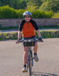 © Franck Legros - Mount St. Odile, France - 09 18 2019: A cyclist girl, after climbing by bike Mount Saint-Odile