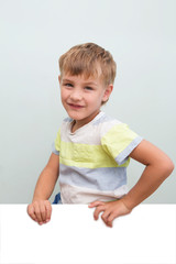 Portrait of happy joyful laughing kid boy  on a gray background. school boy looking at camera. primary school education.