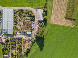 Sticker - Aerial view of greenhouse and vegetables fields in small farming area. Garden center from above.