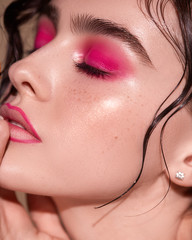 close-up of a young girl with pink smoky eyes