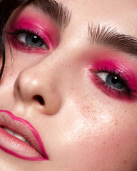 Wall Mural - close-up of a young girl with pink smoky eyes