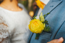 Groom In A Blue Suit With Flower Of Yellow Rose In The Pocket Of Jacket