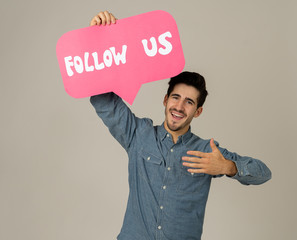 Happy young blogger man holding Follow me social media icon to get followers