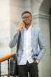 © Alexandr - handsome young african man in a suit phoning