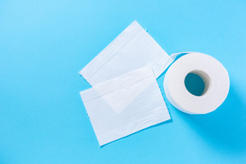 Eco-friendly white toilet paper on a blue background close-up