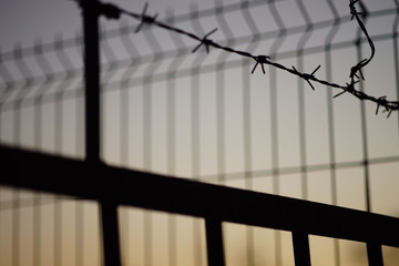 black silhouette of fence in evening, closeup