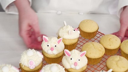 Wall Mural - Step by step. Decorating vanilla cupcakes with white buttercream frosting for Easter.