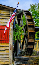 American Flag And Water Wheel On A Rural Restaurant