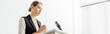 © LIGHTFIELD STUDIOS - panoramic shot of attractive businesswoman standing and talking during conference in office