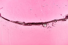 Wavy Clear Fresh Water On Pink Background With Leaking Drops