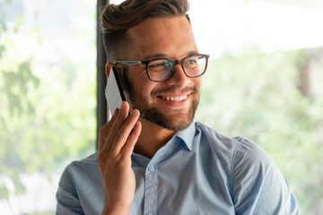 smiling man using mobile phone