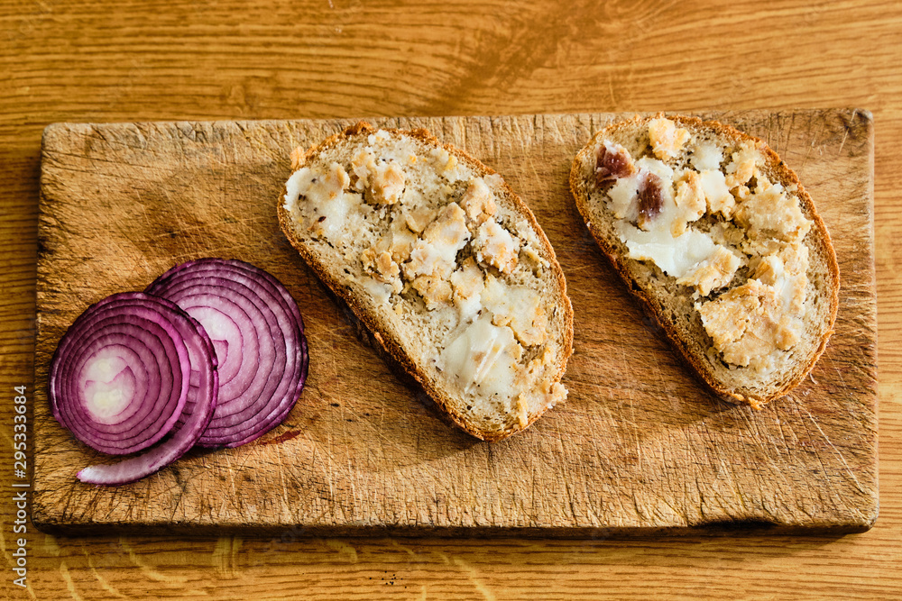 Bread with lard and greaves on cutting board - obrazy, fototapety, plakaty 