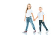 © LIGHTFIELD STUDIOS - happy sister and brother in jeans holding hands on white