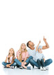 © LIGHTFIELD STUDIOS - happy family pointing with fingers while looking up on white