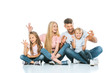 © LIGHTFIELD STUDIOS - happy parents and kids showing ok sign on white