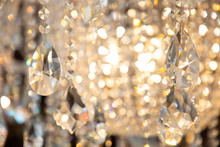 Luxury Hanging Crystal Chandelier Shiny Decoration Interior , Blur Bokeh Light Lamp At Background . Beautiful Electricity Expensive Furniture .
