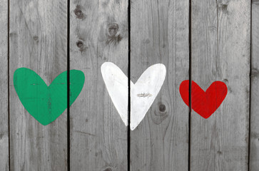 Three hearts of representing the colors of the Italian flag, green, white and red