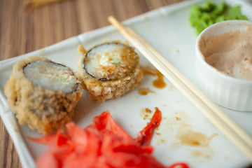 Wall Mural - Empty dirty plate of sushi on table in cafe